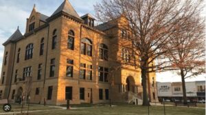 A large building with a clock tower in the background.